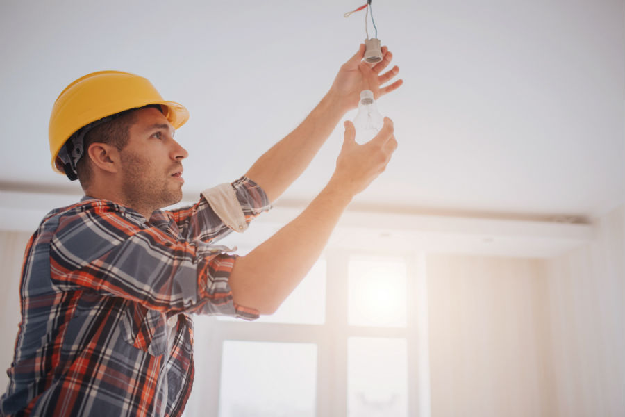 A man performing electrical home maintenance tasks